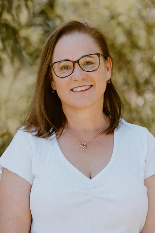 A headshot of Alison Stewart, Dietitian. She has shoulder length brown hair, glasses and is wearing a white top.